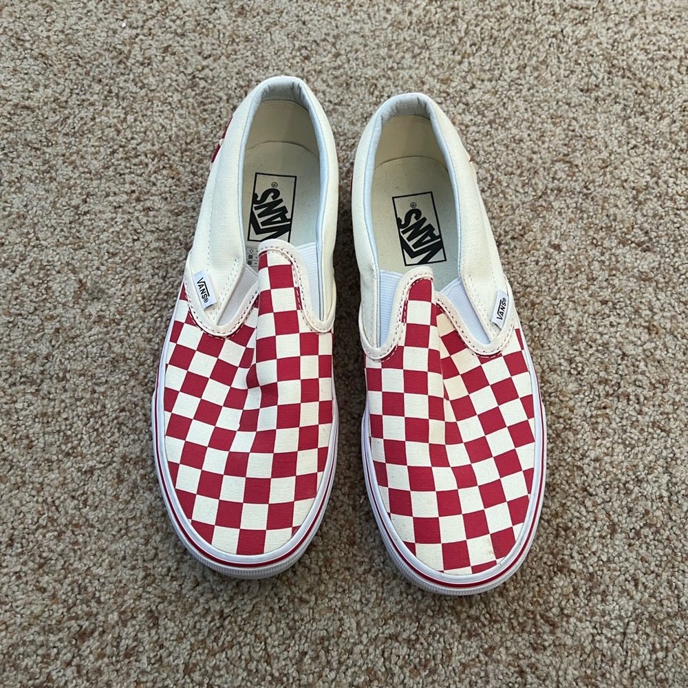 Checkerboard slip on vans in red